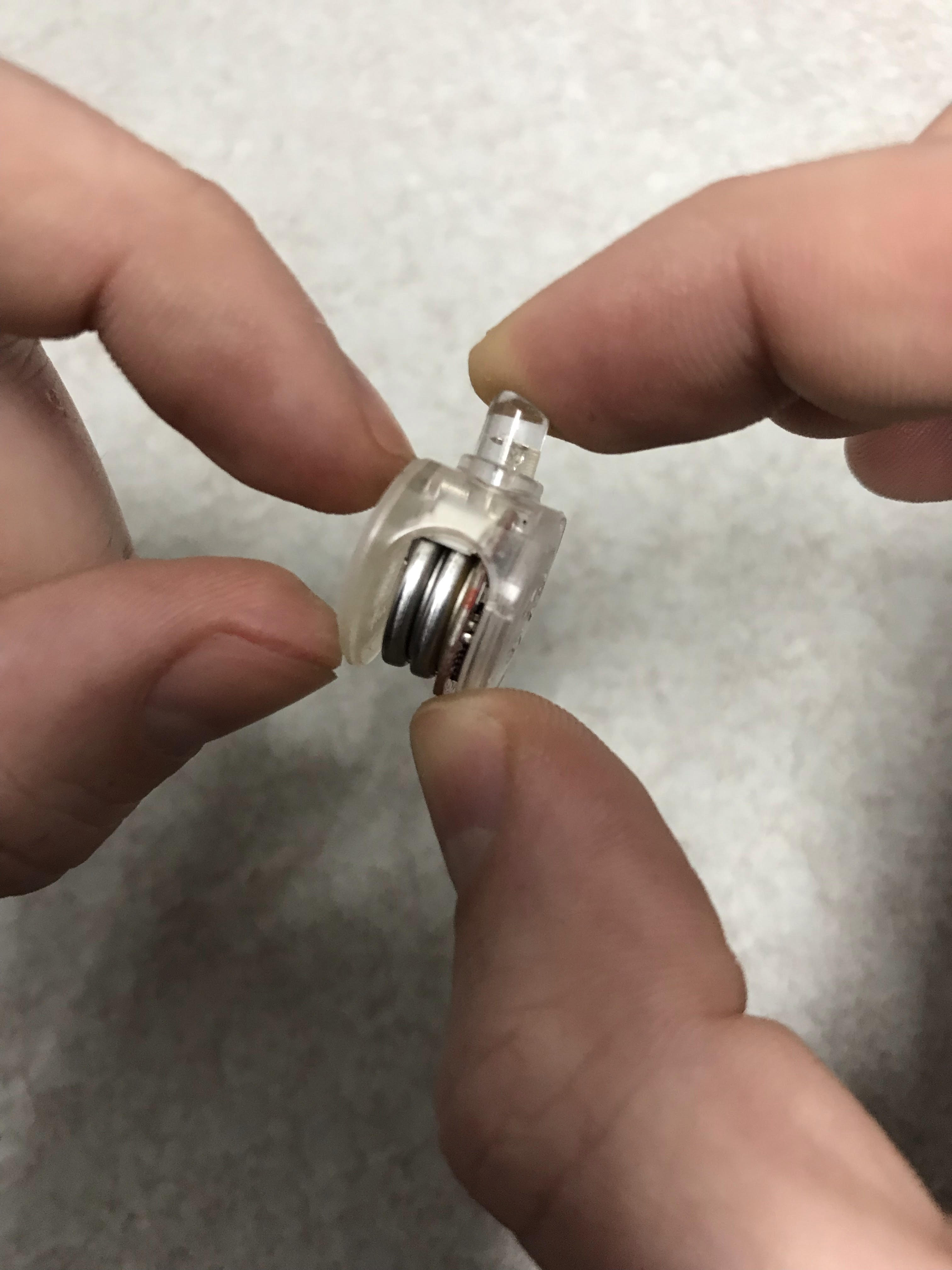 Place your fingers on the casing and the bulb