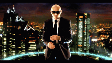 Pitbull rubbing his hands in front of a shot of a city